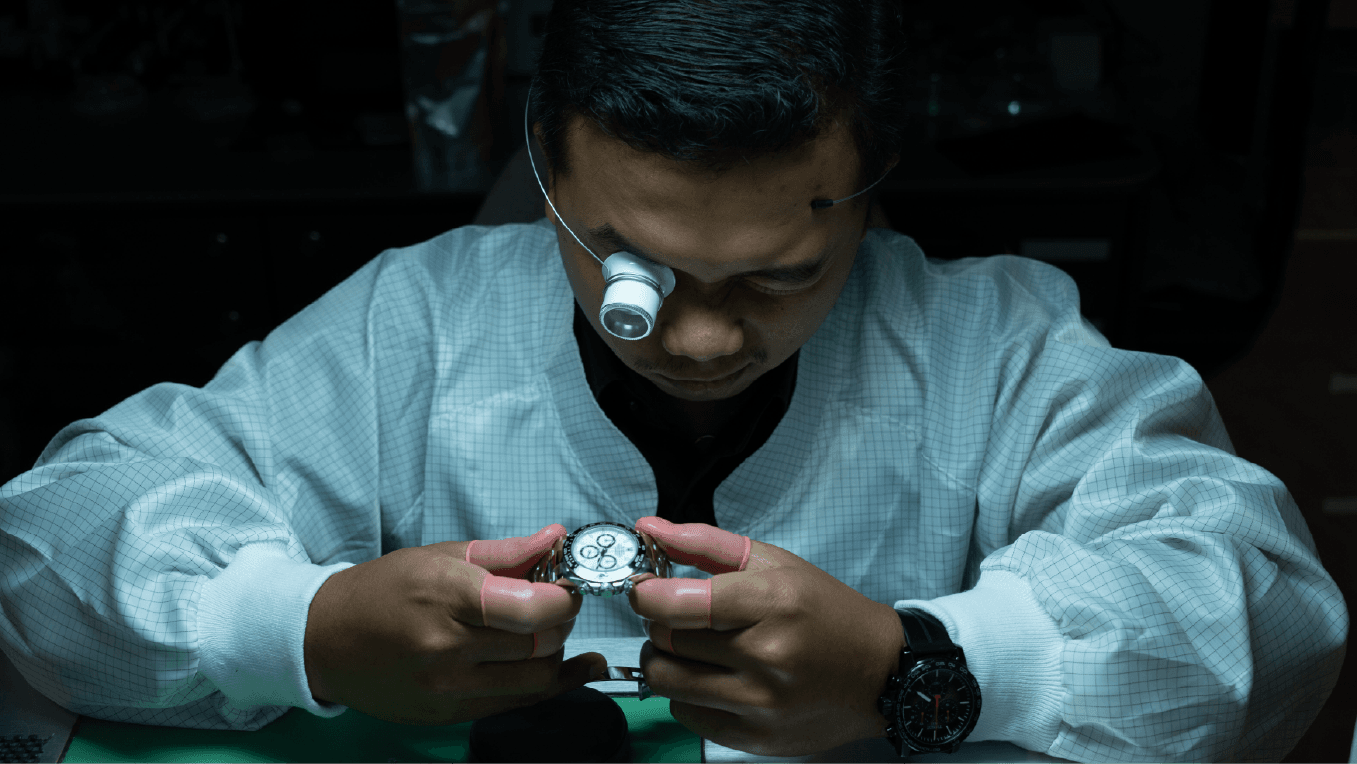 A Watches Trader Watch Expert inspecting a timepiece with a loupe
